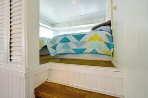 A bedroom with a bed, a window, and a wooden floor. - Heated Pool, Games & Socials! Zephyrhills Home (Zephyrhills)
