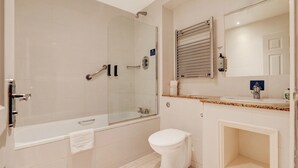 A modern bathroom with a walk-in shower, a bathtub, a toilet, and a vanity with a mirror. - Standard family of 5 room (Liverpool)