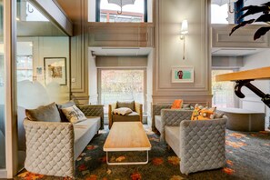 A modern living room with a sofa set, a coffee table, and a decorative umbrella. - Manchester Portland By Sunday - Standard Single Room (Manchester)