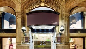 An ornate hotel entrance with a sign reading 'Manchester portland hotel.' - Standard Double Room (Manchester)
