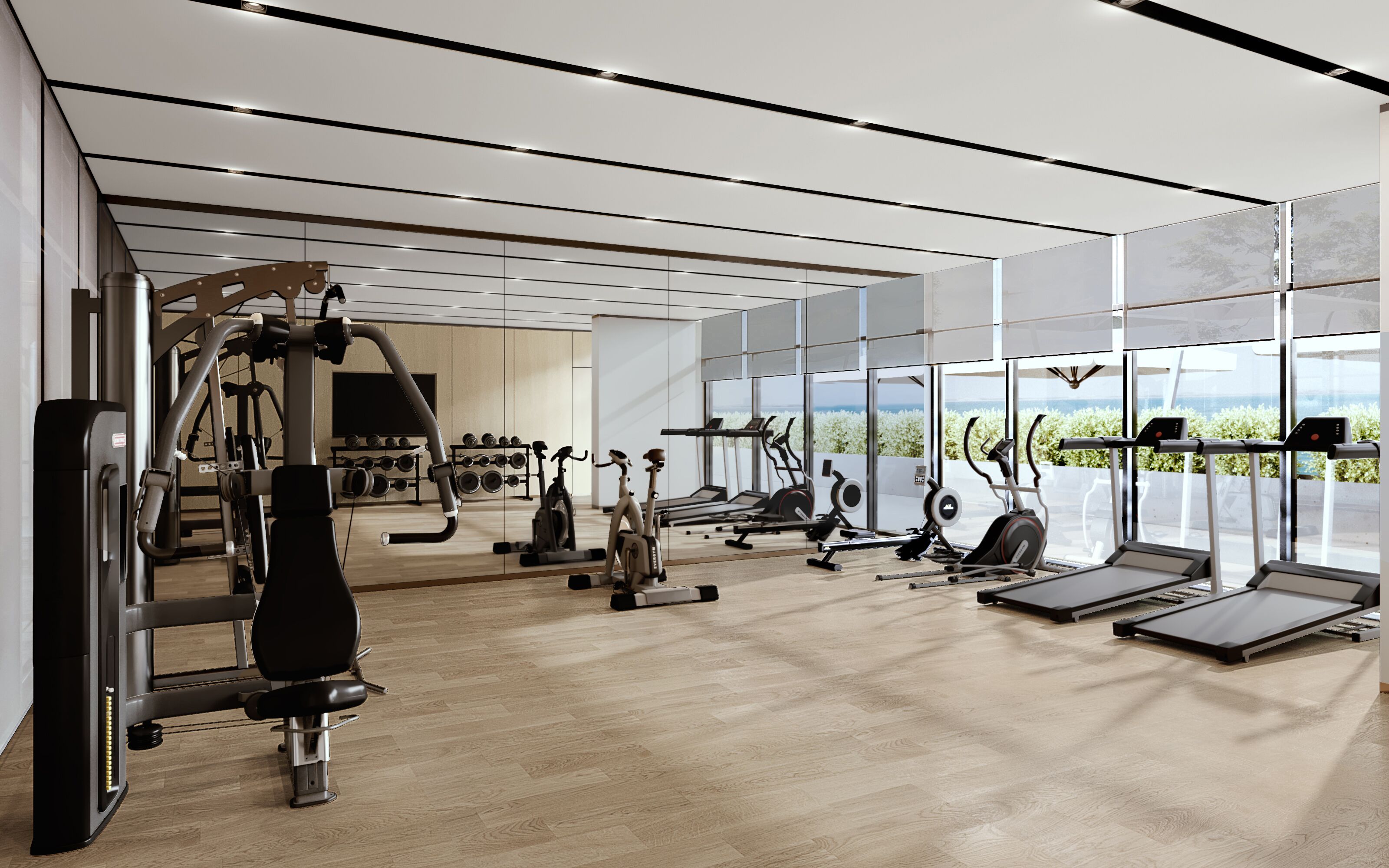 A modern gym with various exercise equipment, large windows, and a wooden floor.