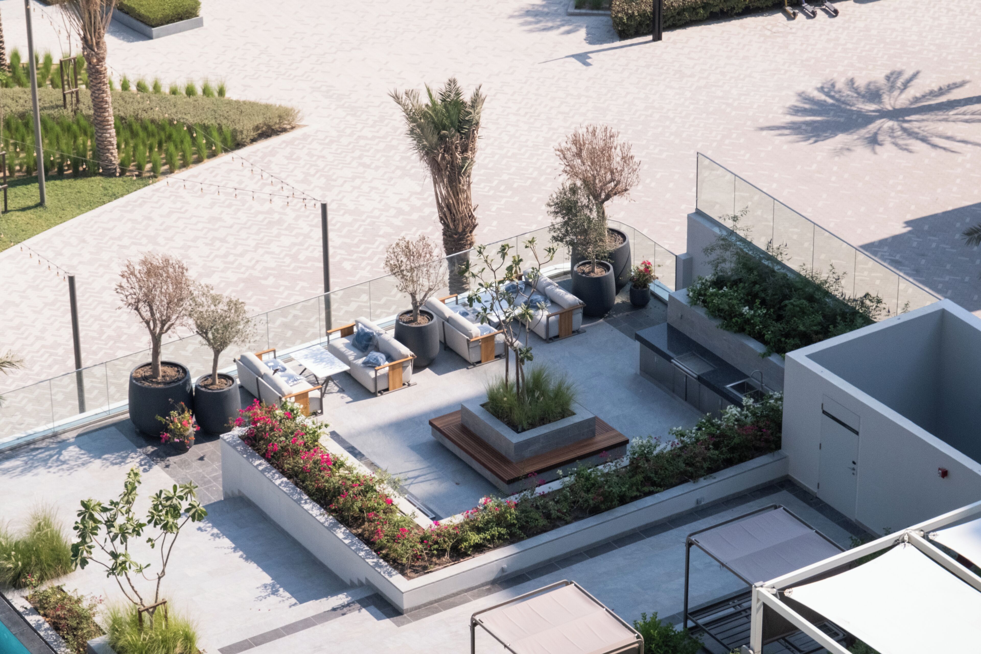 An outdoor seating area with planters and a modern architectural design.