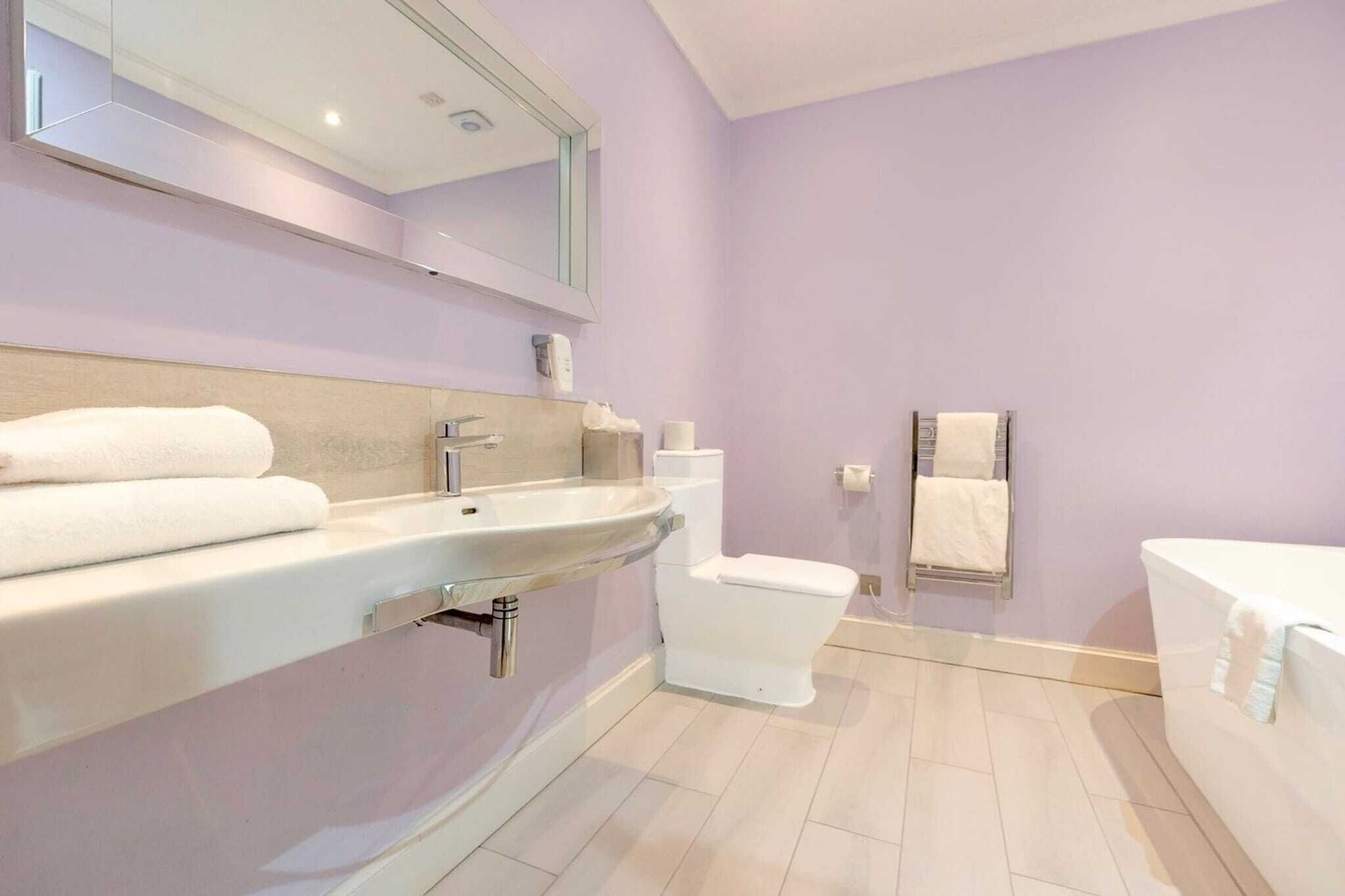 A bathroom with a sink, toilet, and bathtub.