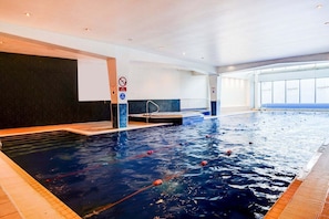 An indoor swimming pool with lanes, a diving board, and a no diving sign. - Holland House Hotel By Sunday Triple Room (Cardiff)