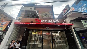 A storefront with a sign reading 'OPTIK VP' and a visible entrance.