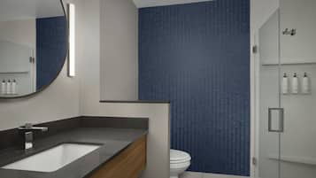 Un baño moderno con un espejo grande, un lavabo y un inodoro.