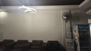 A room with massage chairs, a water dispenser, a fan, and a vending machine. - Barkah Balikpapan Deluxe Double (Balikpapan)