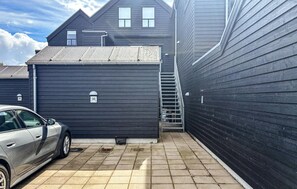 A residential building with a garage, a car parked in front, and a visible number 36 on the garage door. - 2 bedroom nice apartment in Samsø (Samsø)