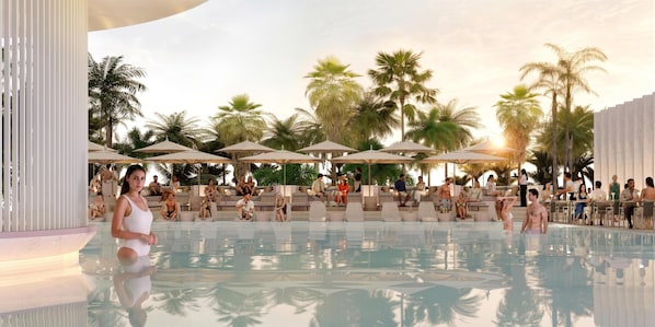 A poolside area with lounge chairs and umbrellas, surrounded by palm trees.