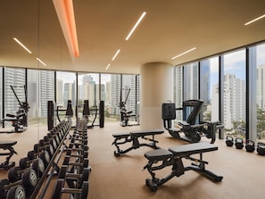 A gym with exercise equipment, large windows, and a city view. - Andaz Gold Coast by Hyatt (GOLD COAST)