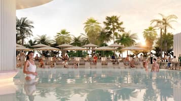Un área junto a la piscina con sillones de descanso y sombrillas, rodeada de palmeras.