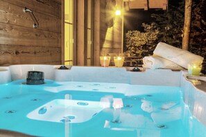 A hot tub with a wooden wall and a window.