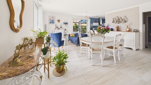 A spacious living area with a dining table, chairs, sofas, and a large mirror. - House with garden, 7 adults 1 child (Saint-Michel-Chef-Chef)
