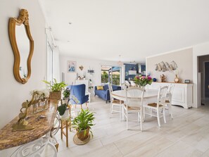 A spacious living area with a dining table, chairs, sofas, and a large mirror. - House with garden, 7 adults 1 child (Saint-Michel-Chef-Chef)