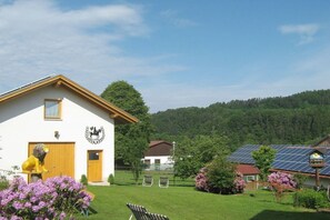Ein Gebäude mit einer Löwenstatue, einem Tennisplatz und Solaranlagen.