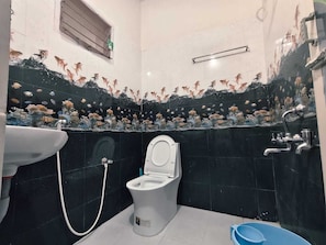 A bathroom with a toilet, sink, and shower. - Aala Homestay (Palayankottai)