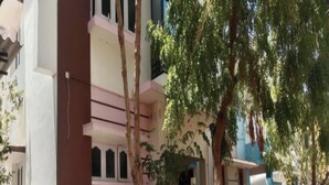 A multi-story residential building with balconies, a gated entrance, and surrounding greenery. - Aala Homestay (Palayankottai)