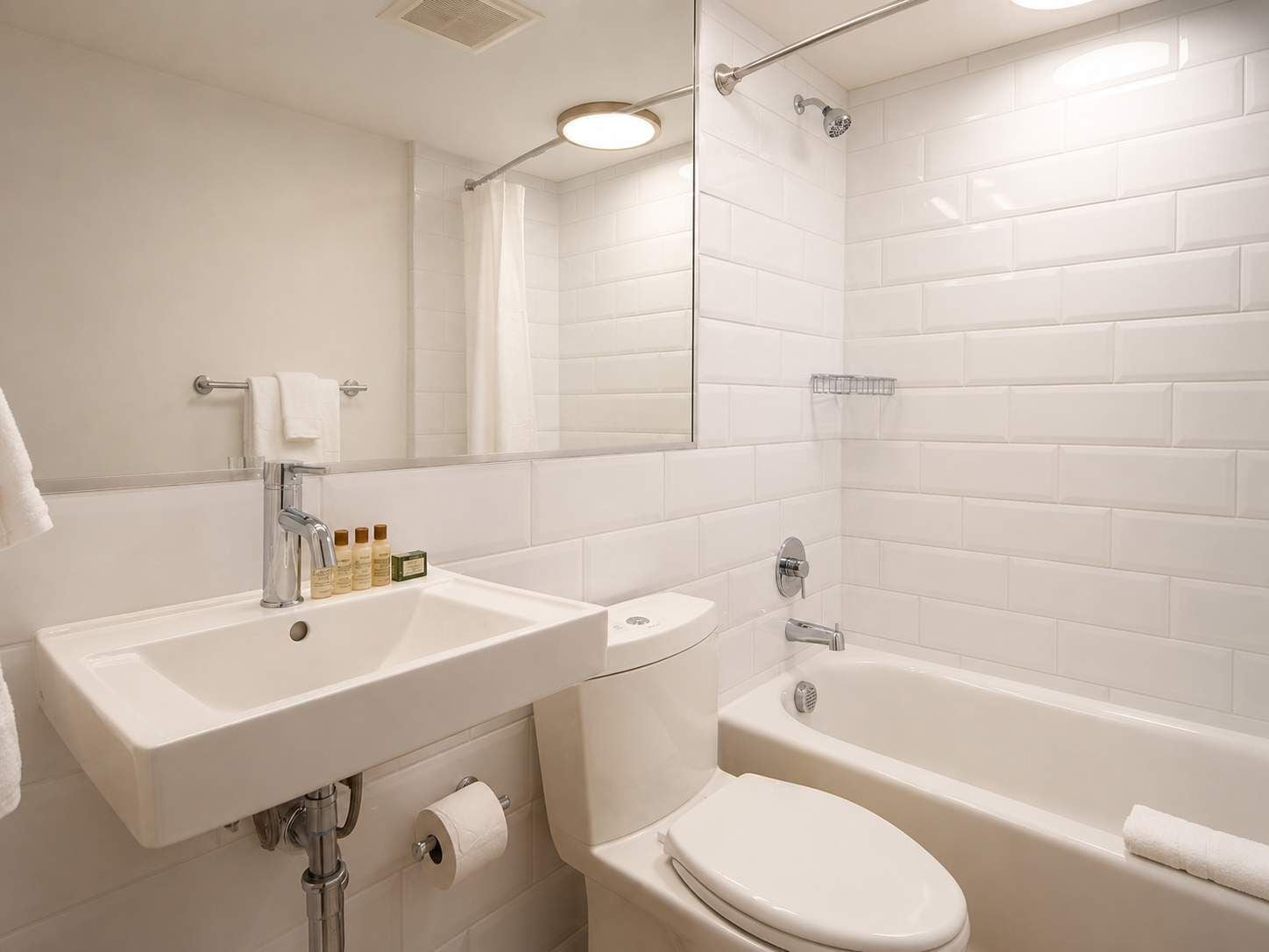 A bathroom with a sink, toilet, and bathtub.