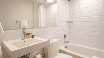 A bathroom with a sink, toilet, and bathtub.