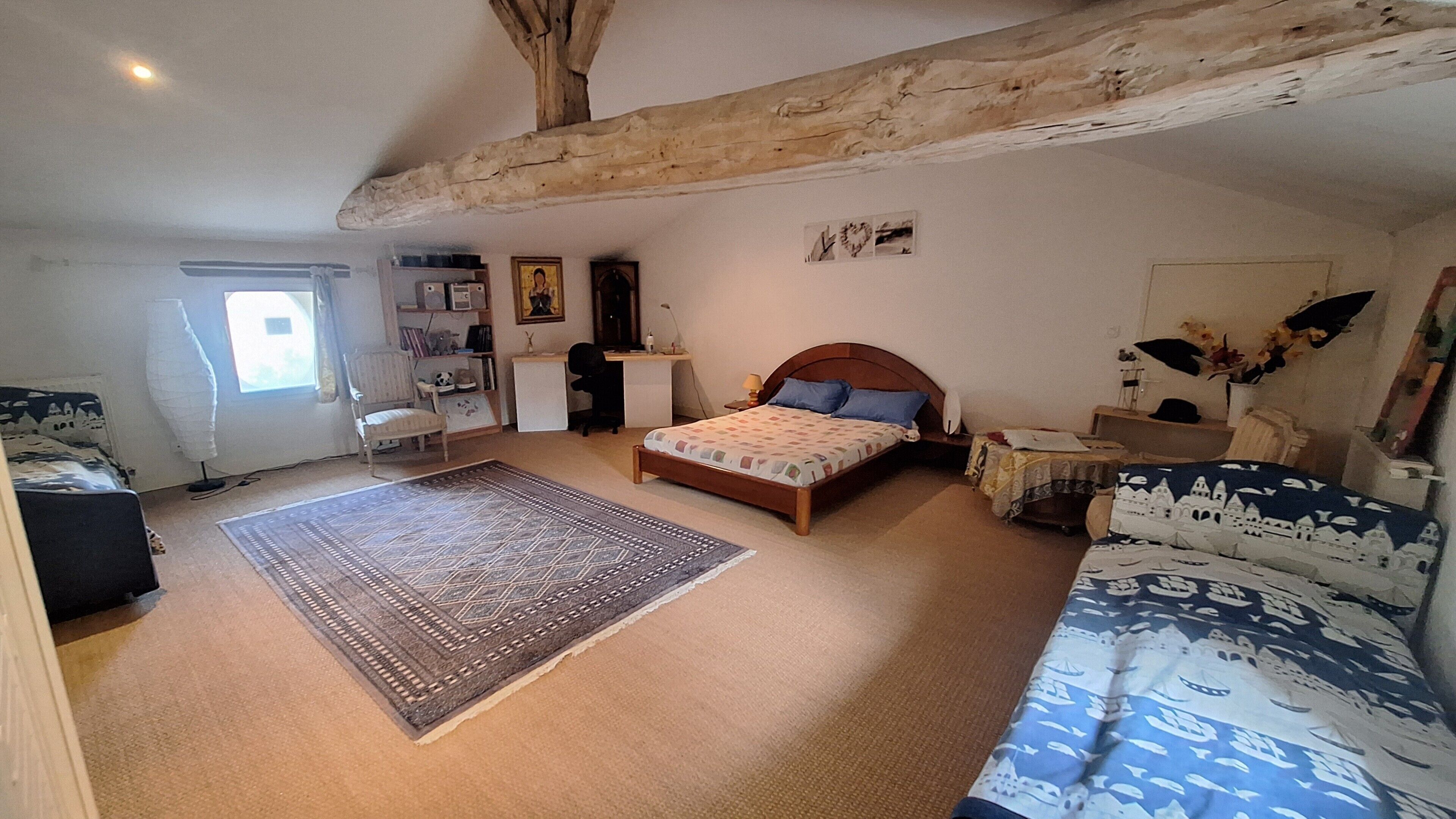 A bedroom with a bed, a desk, a chair, a rug, and a window.. Bed and Breakfast 'Chambre Famille Cabernet Ch Cajus -' with Shared Pool, Shared Terrace and Wi-Fi