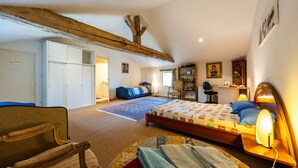 A bedroom with a bed, a desk, a chair, a wardrobe, and a large window. - Guest Room “Famille Cabernet Ch Cajus” with Shared Pool, Terrace, and Wi-Fi (Saint-Germain-du-Puch)