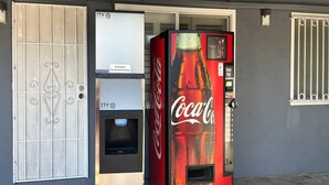 A vending machine and a door with a security lock. - 2 Full Beds|Nsmk, Micfridge (Oakland)