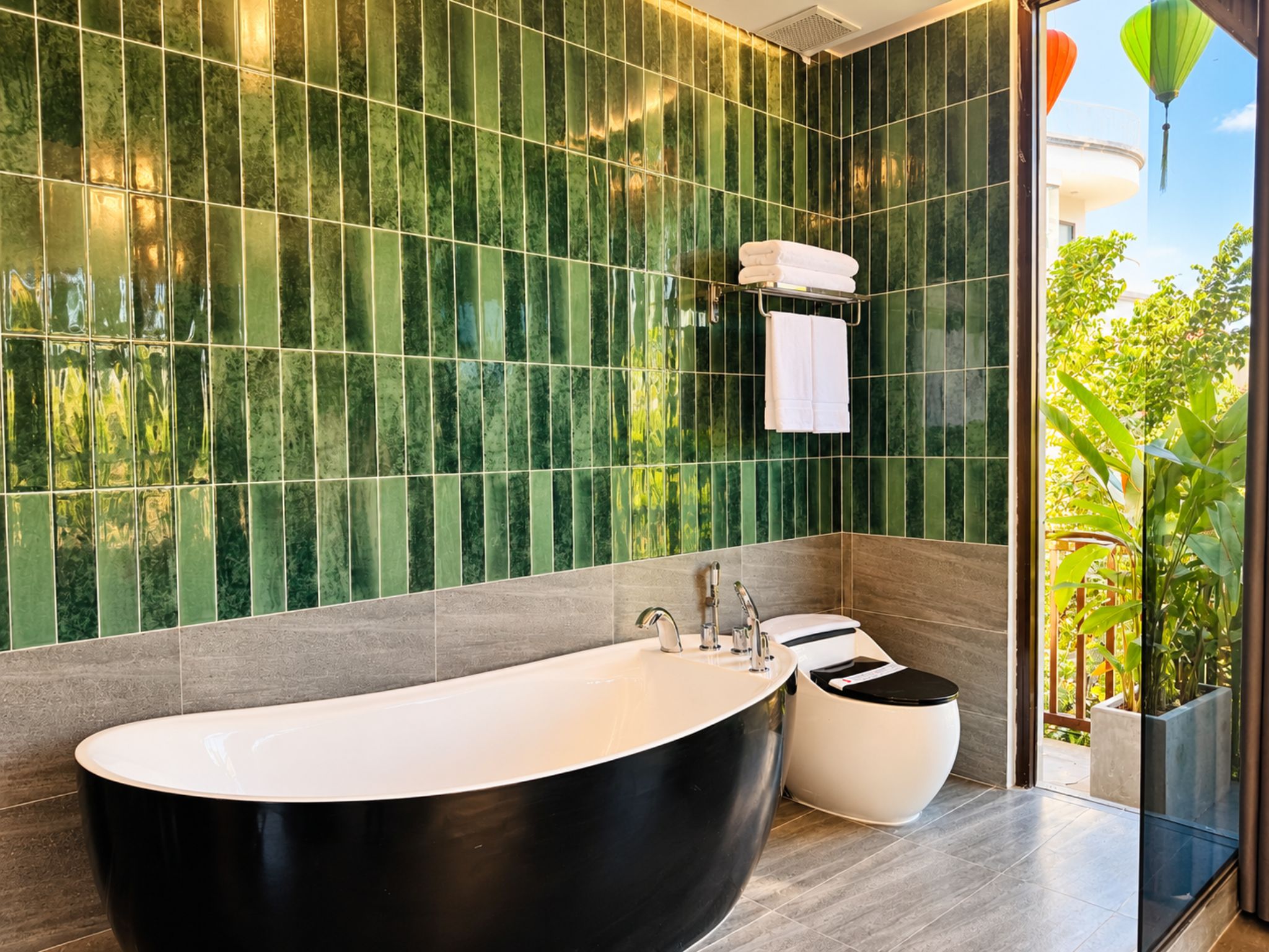 A modern bathroom with a freestanding bathtub, a toilet, and a sink.