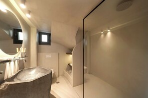 Suite Deluxe, vistas parciales al mar | Baño | Ducha, artículos de higiene personal gratuitos, toallas y jabón