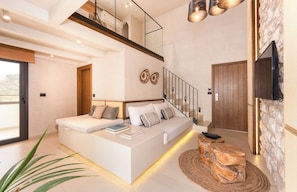 Suite Deluxe, vista parcial al mar | Área de sala de estar
