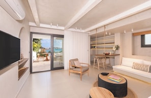 Suite de lujo, vista al mar | Área de sala de estar