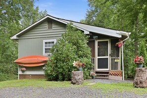 A small, single-story building with a porch, a large window, and a door. - Whittier Cabin Retreat for Large Groups (Whittier)