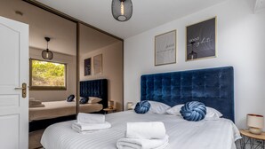 A hotel room with a large bed, a mirror, a window, and two framed motivational posters. - MC Riviera: Modern Apartment With Stunning sea View and Terrace Near Monaco (Beausoleil)