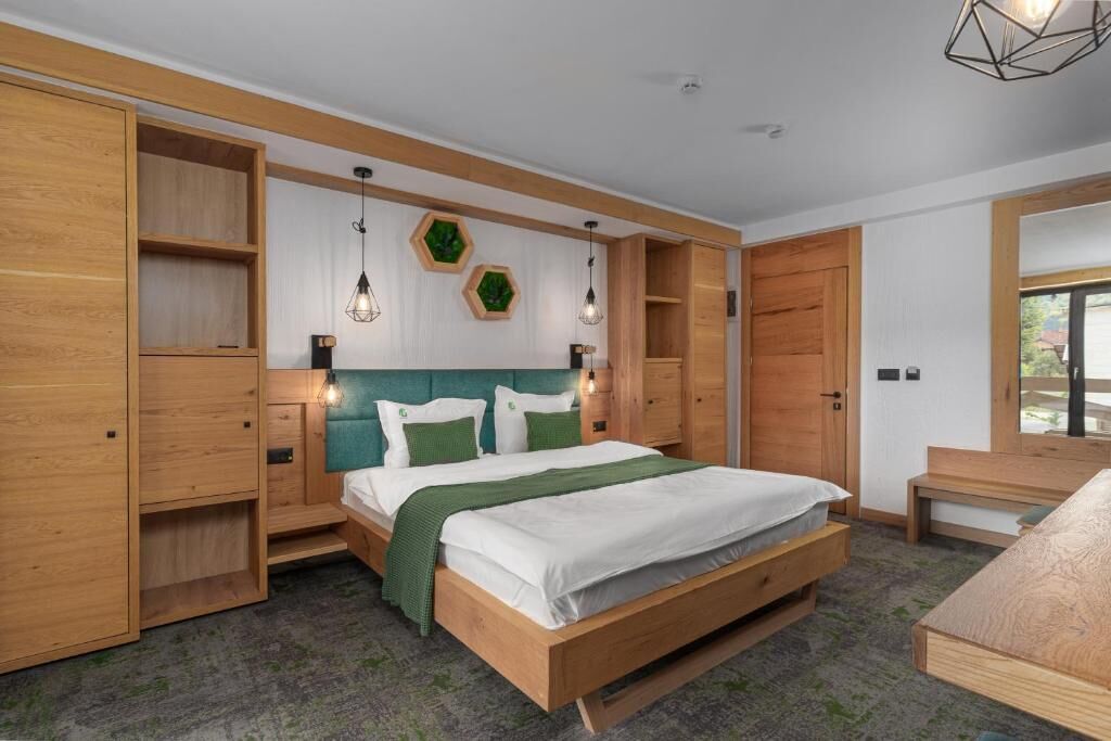A bedroom with a wooden bed, built-in shelves, and a desk.