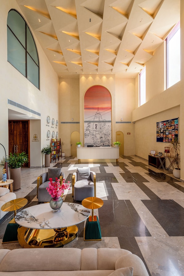 A spacious lobby with a reception desk, seating area, and a large mural. - Tree of Life Ganga Dwar Haridwar (Haridwar)