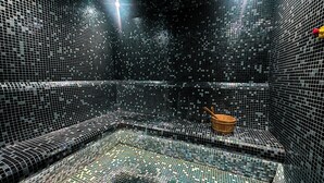 A room with a tiled floor and walls, a wooden bucket, and a spoon on the floor. - Luxury Burj Khalifa & Canal View Studio (Dubai)