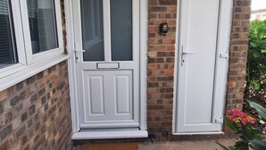 A house entrance with a white door, a window with blinds, and a welcome mat. - 3 BEDROOM + LIVING, Terrace House, Sleeps up to 7 people  with Garden (Cardiff)