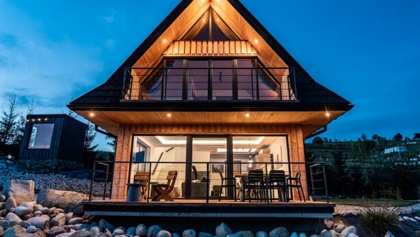 A modern house with a wooden exterior, large windows, and a balcony. - Holiday Home With Sauna and Mountain View (Bukowina Tatrzanska)