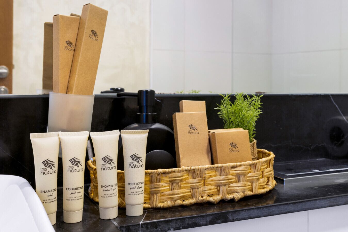 A bathroom counter with toiletries including shampoo, conditioner, shower gel, and body lotion, all labeled 'LOVO natura.'