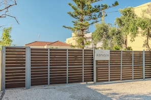 A gated entrance with a sign reading 'ASPASIA HOUSE.'