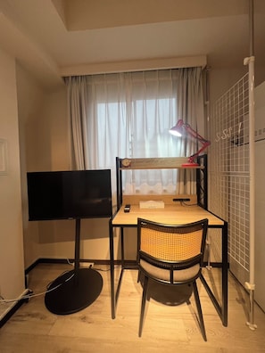 A compact room with a desk, chair, television, and a bed. - Dash Living Ryogoku (Sumida City)