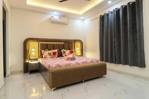 A bedroom with a bed, nightstands, an air conditioner, and a curtain. - 4 Bedroom Farmhouse With Private Pool In Noida (Nodia)