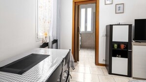 A room with a bed, a desk, a chair, a wardrobe, and a television. - Guesthost - N&D Studio Modena Center (Modena)