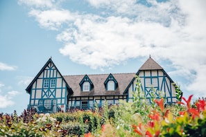 A traditional half-timbered house with a symmetrical facade, multiple gabled roofs, and a central entrance. - Sea View Houlgate Apartment for 4 (Houlgate)