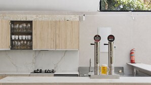A kitchen with a marble countertop, a wooden cabinet with glassware, and two beer taps labeled 'Estrella Galicia.' - Villa Tropical |Pool|Jacuzzi|Bar|BBQ|AC|16 Pax (VALENCIA)
