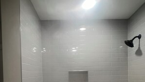 A bathroom with a bathtub, a showerhead, and a recessed ceiling light. - Plush 3b/2b house on ATL lovely WestEnd. Next to 2 Marta St. 10 min from M Benz. (Atlanta)