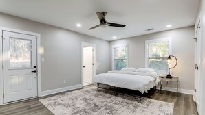 A bedroom with a bed, a ceiling fan, a nightstand, and a window. - Plush 3b/2b house on ATL lovely WestEnd. Next to 2 Marta St. 10 min from M Benz. (Atlanta)