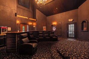 A room with a bar area, seating, and an exit sign. - Ski Mountain Manor: Big Screen, Bigger Memories (Gatlinburg)