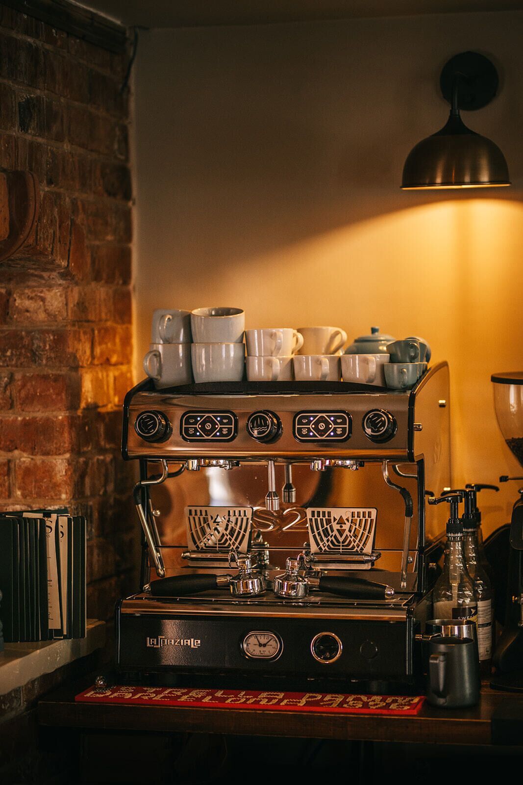 A coffee machine with multiple brewing options, a clock, and a branded coffee pot.