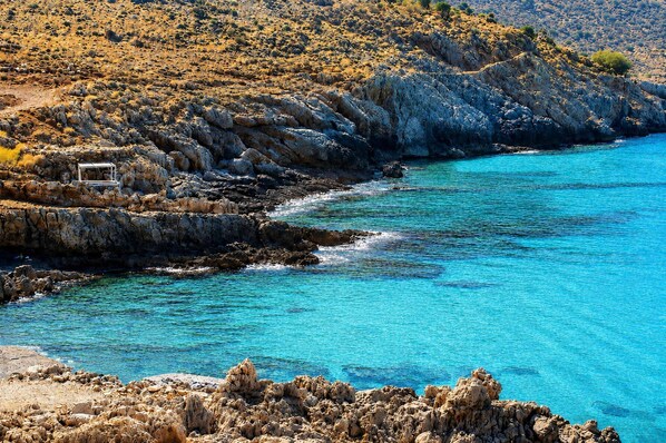 A coastal landscape with rocky terrain and clear blue waters. - Bon Filius - Luxury Private Villa w Pool in Chania (Apokoronas)