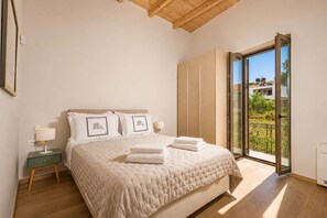 A bedroom with a bed, bedside table, and a view of the outside. - Bon Filius - Luxury Private Villa w Pool in Chania (Apokoronas)
